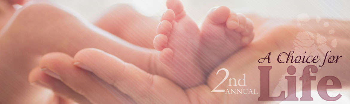 newborn feet resting in mom's hands